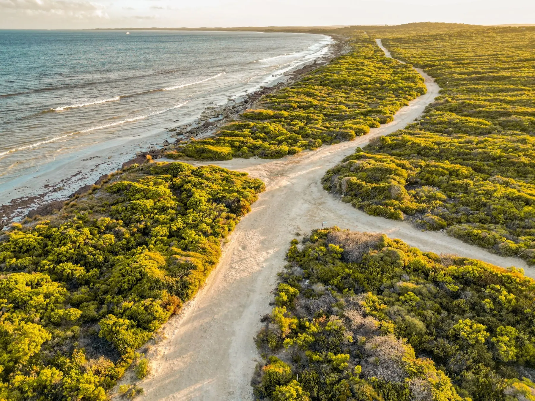 Aerial view of the coast road tracing the dunes at D'Estrees Bay