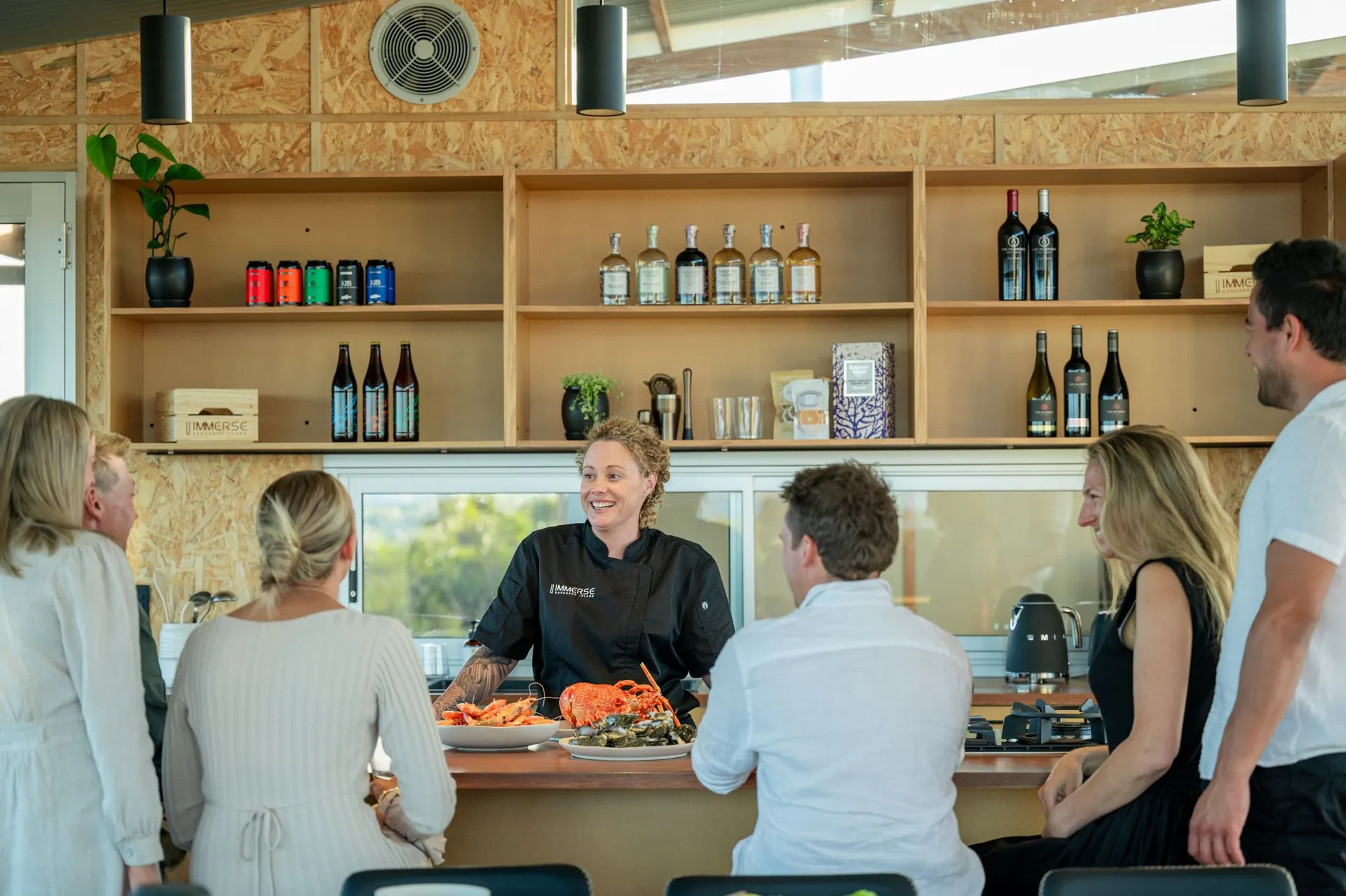 The Immerse chef serving guests at the bar during an Immerse Impressions stay