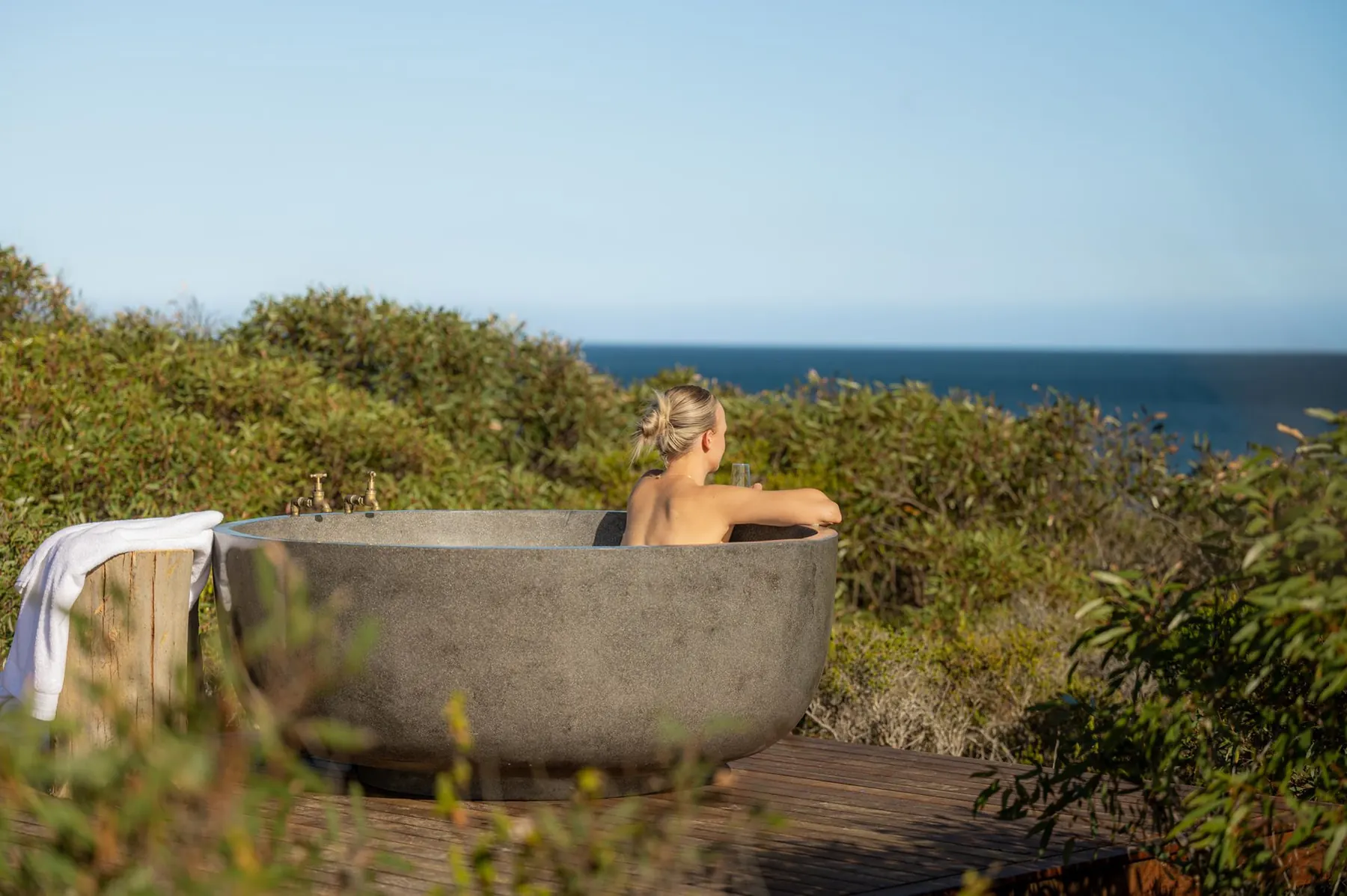 Stone outdoor bath on the deck overlooking the Southern Ocean