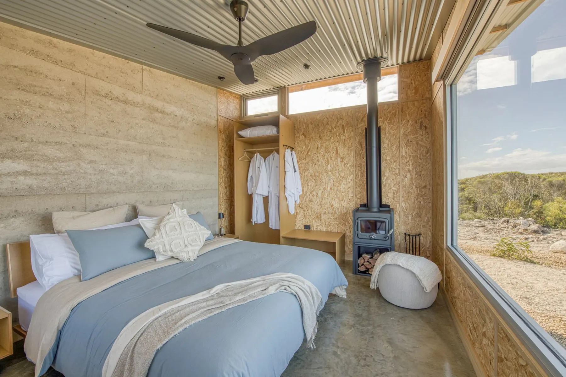 Fourth bedroom with two king single beds looking out to coastal heath